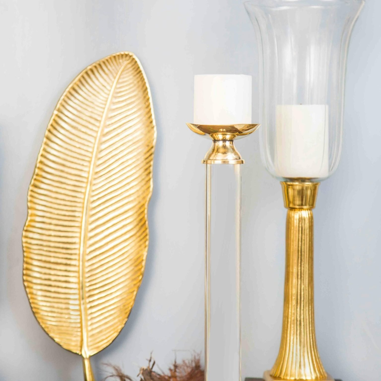 Stylish gold and glass decorations with candle holders for luxurious interior decor.