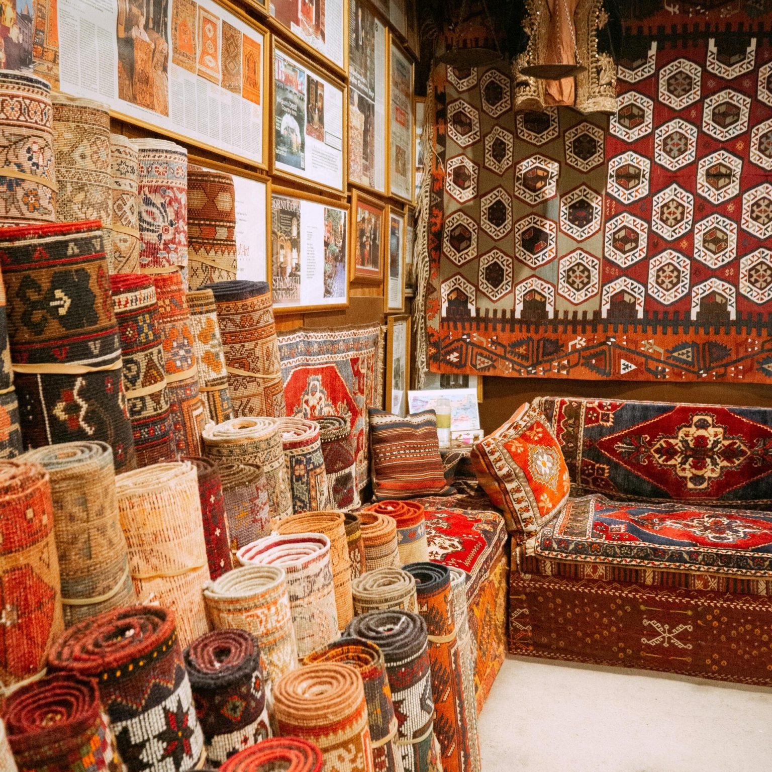 Vibrant display of rolled Turkish carpets in an Istanbul bazaar, showcasing intricate patterns and rich colors.